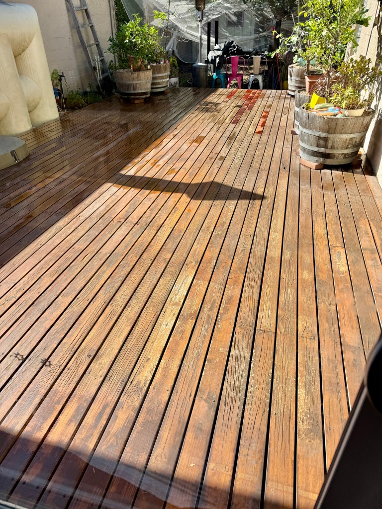 Image is a scrubbed and washed wooden deck, ready for painting
